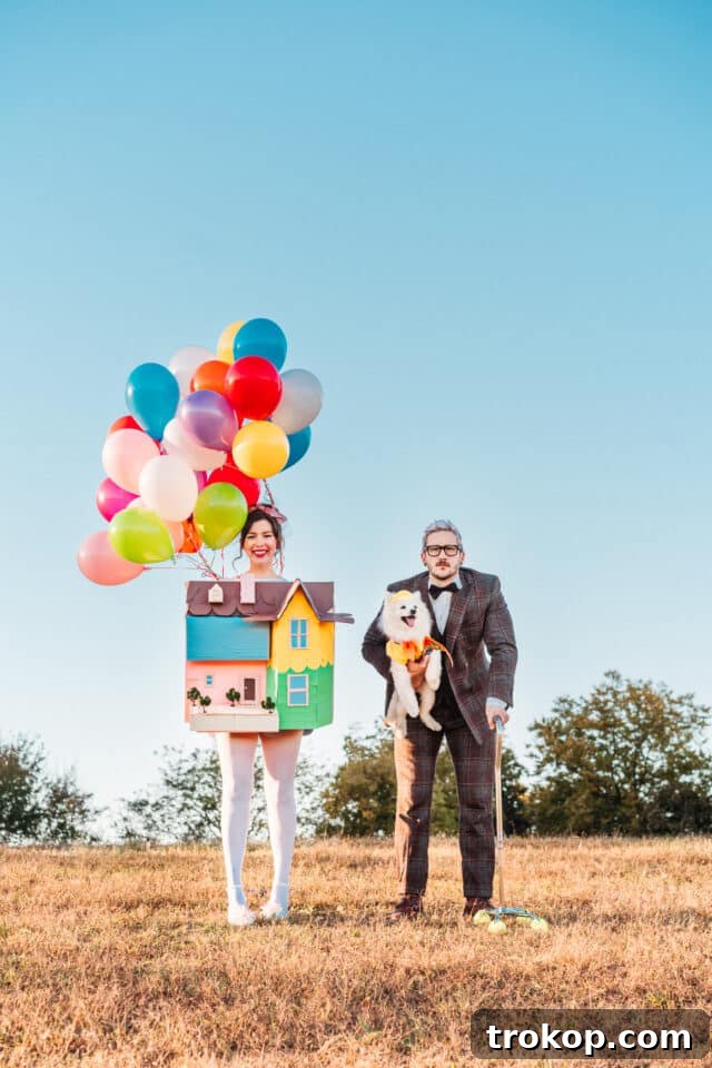 22 Pawsome Matching Halloween Costumes for Couples and Their Dogs 5 Couple dressed as Carl and Russell from Disney's Up, with their dog as the Up house, a heartwarming Halloween costume.