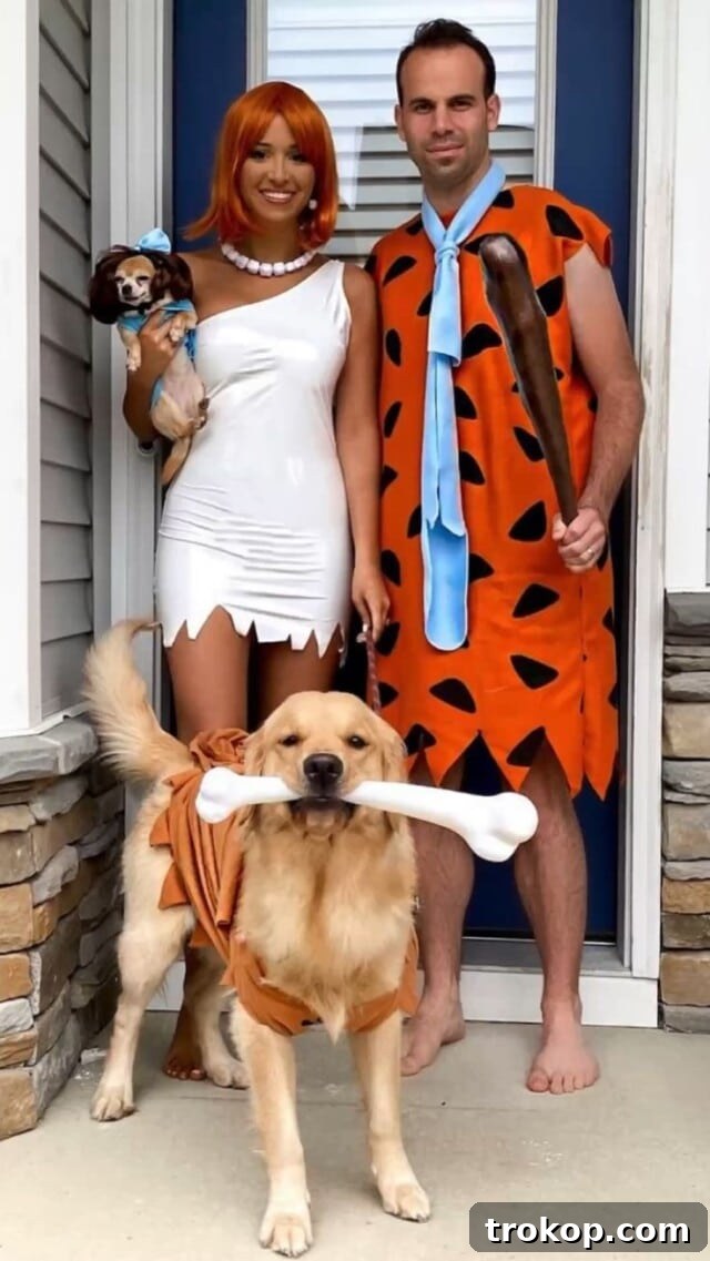 22 Pawsome Matching Halloween Costumes for Couples and Their Dogs 7 Flintstones Halloween costume featuring Fred, Wilma, and Dino for a couple and their dog.