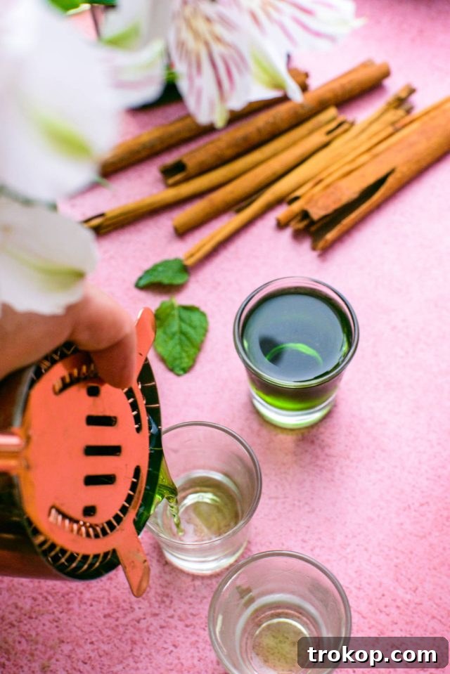 Pouring the Liquid Cocaine mixture into shot glasses, ready to serve.