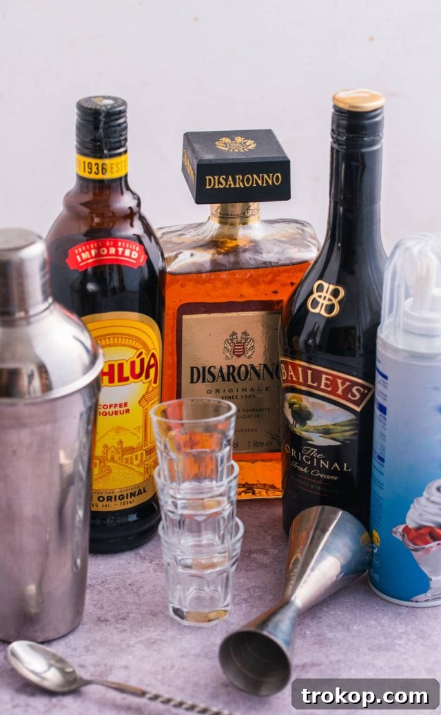 A selection of high-quality liqueurs: Kahlua, Amaretto, and Baileys Irish Cream, essential for crafting the perfect Blow Job Shot.
