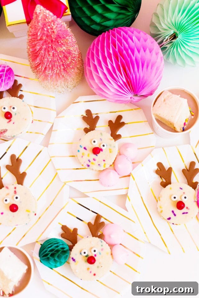 Holiday Cookie Masterclass: Recipes for Delicious Treats and Stunning Displays 16 Adorable Funfetti Reindeer Cookie Sandwiches with pretzel antlers, filled with creamy frosting, perfect for a festive treat.