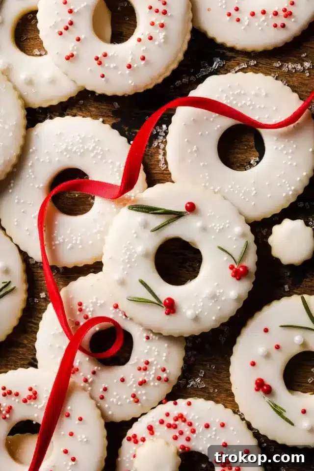 Holiday Cookie Masterclass: Recipes for Delicious Treats and Stunning Displays 17 Delicate Lemon Wreath Cookies, beautifully piped with green frosting and festive sprinkles, ideal for Christmas cookie trays.