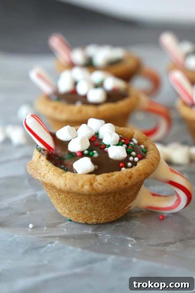 Holiday Cookie Masterclass: Recipes for Delicious Treats and Stunning Displays 18 Creative Hot Chocolate Cookie Cups, resembling miniature mugs of hot cocoa with whipped cream and peppermint candy canes.