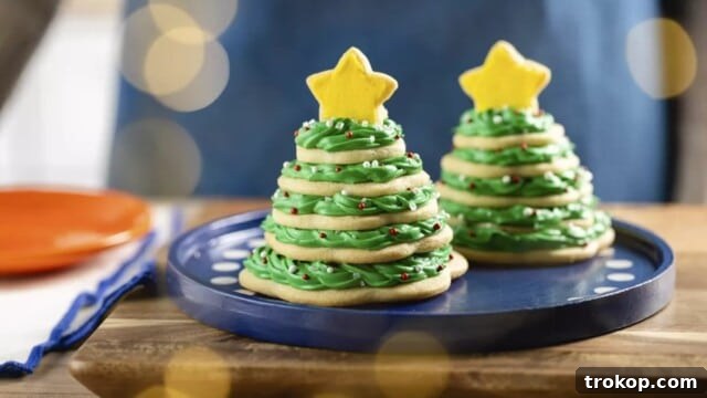 Holiday Cookie Masterclass: Recipes for Delicious Treats and Stunning Displays 22 Festive Christmas Cookie Trees, constructed from stacked star-shaped cookies and adorned with green frosting and decorations.
