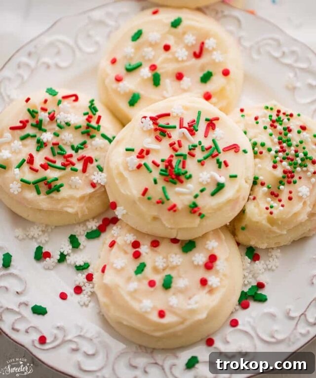 Holiday Cookie Masterclass: Recipes for Delicious Treats and Stunning Displays 24 Soft Frosted Eggnog Cookies, drizzled with a rich eggnog frosting and a sprinkle of nutmeg, perfect for Christmas.