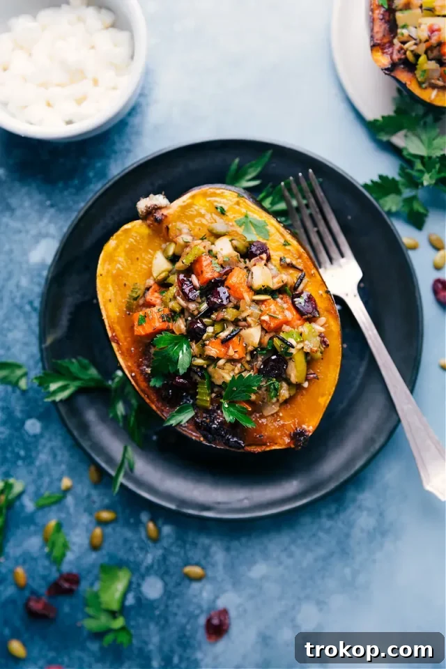 Stuffed Acorn Squash with roasted sweet potatoes, pepitas, and apples, a festive Christmas side.