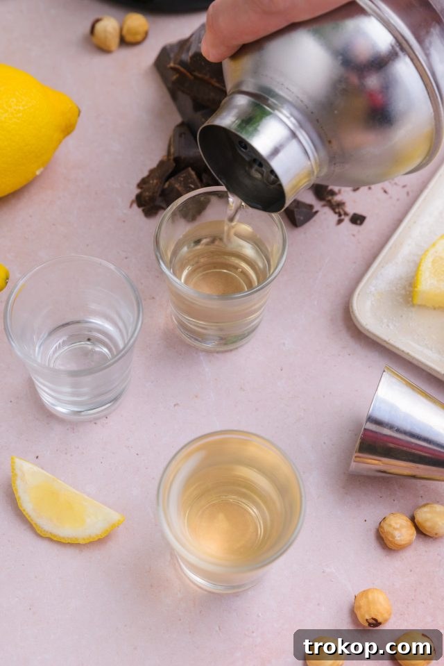 Pouring the Chocolate Cake Shot mixture into shot glasses, ready to serve