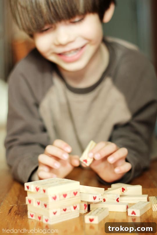Creative Valentine's Day Party Concepts 28 Valentine’s Day Tumble Game, a Jenga-style game with blocks decorated for Valentine's Day.