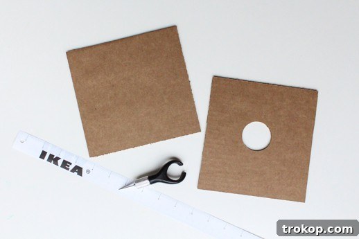 Reclaimed Cardboard Pendant Design 4 Collection of tools and materials for DIY cardboard pendant light, including cardboard, light kit, ruler, and cutting tools