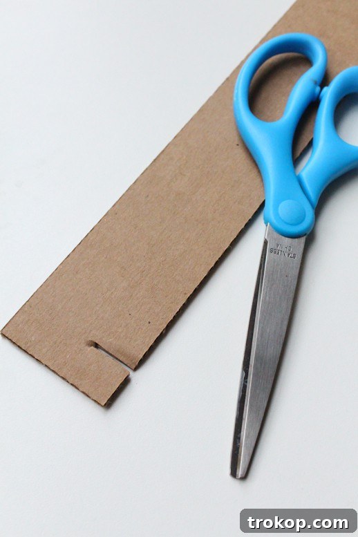 Reclaimed Cardboard Pendant Design 5 Detailed view of cutting and marking cardboard strips for the DIY pendant light