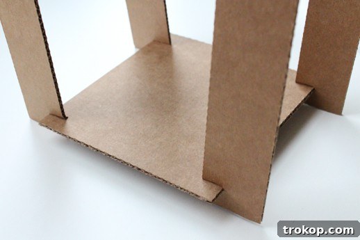 Reclaimed Cardboard Pendant Design 6 Assembling the cardboard frame for the pendant light, interlocking strips into the base