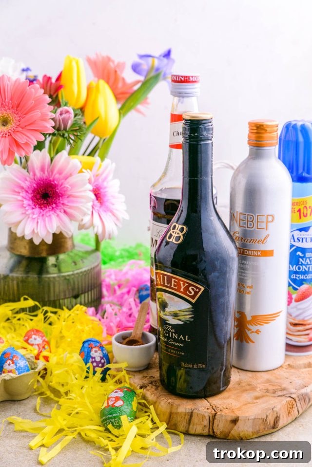 Easter's Colorful Shot Creations 3 Ingredients needed to make delicious Easter Egg Shots, including hollow chocolate eggs, liqueurs, and garnishes.