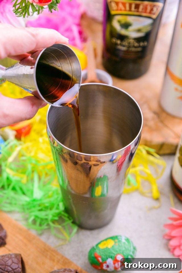 Easter's Colorful Shot Creations 4 Adding caramel vodka to a cocktail shaker filled with ice, a step in making Easter Egg Shots.