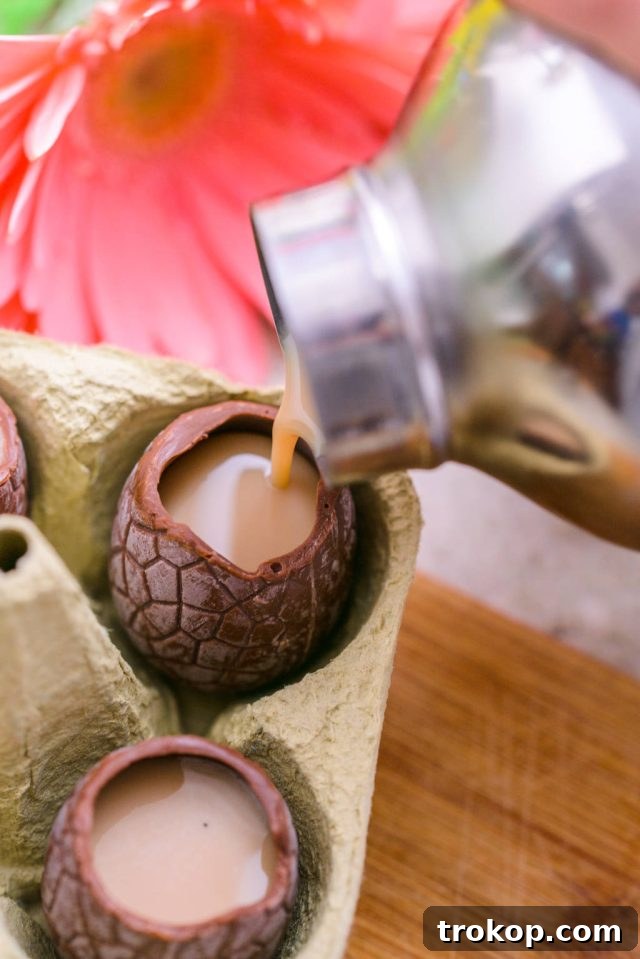 Easter's Colorful Shot Creations 5 Pouring the creamy cocktail mixture into a hollow chocolate Easter egg, ready for serving.