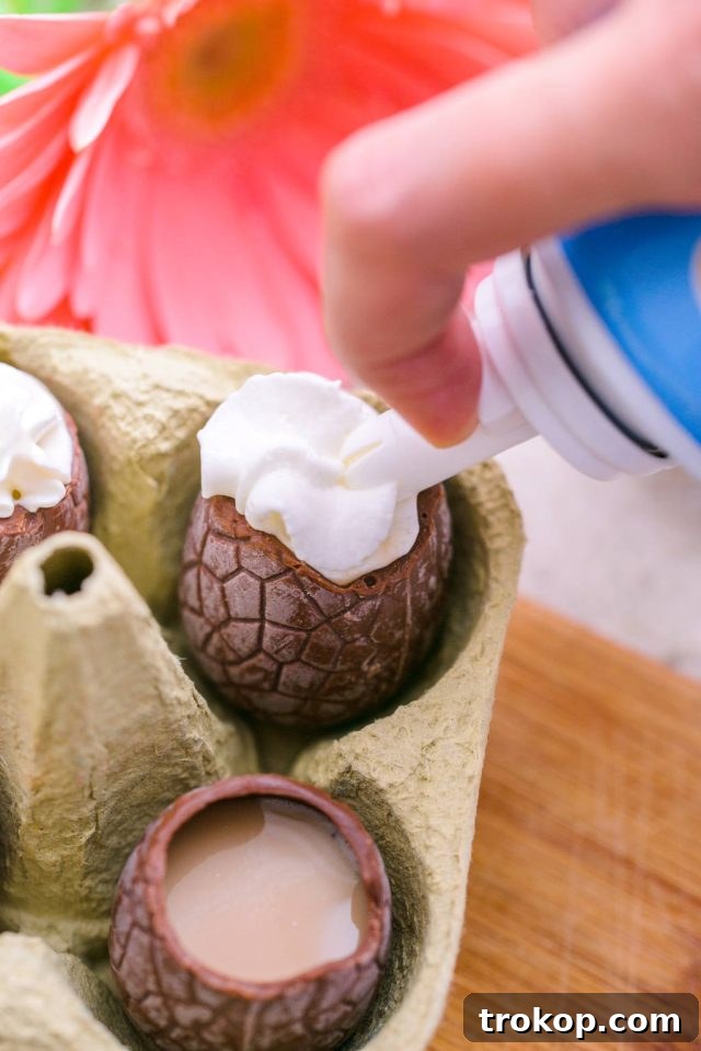Easter's Colorful Shot Creations 6 Topping Easter Egg Shots with a swirl of whipped cream and a sprinkle of cacao powder for garnish.