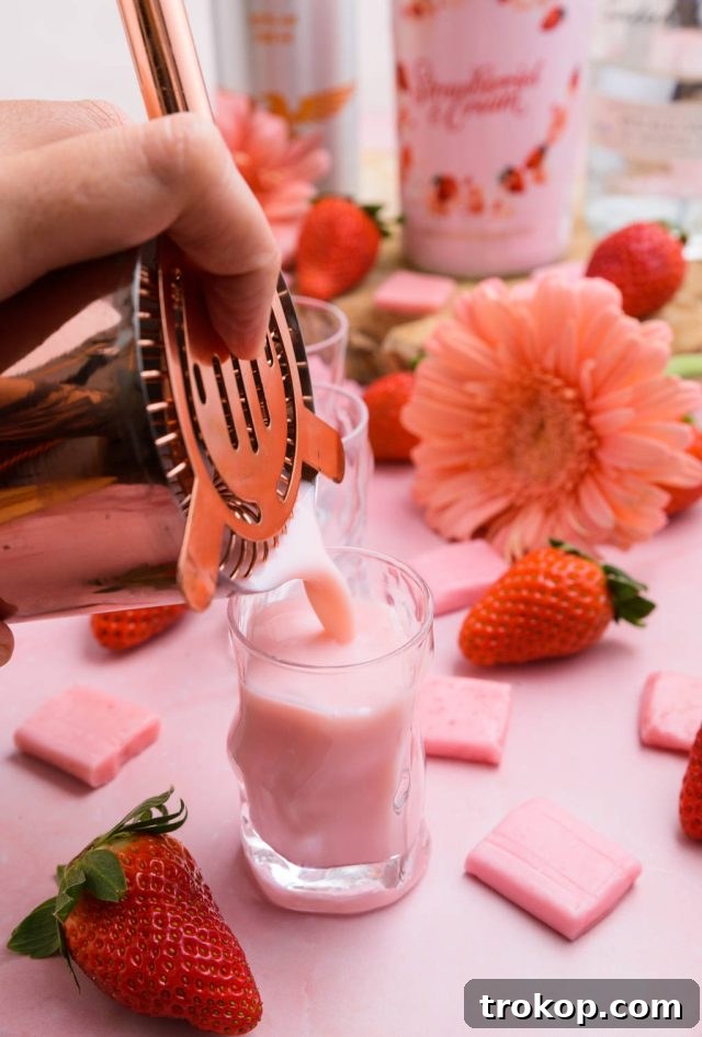 Serving the Pink Starburst shot in a chilled shot glass, ready to be enjoyed.