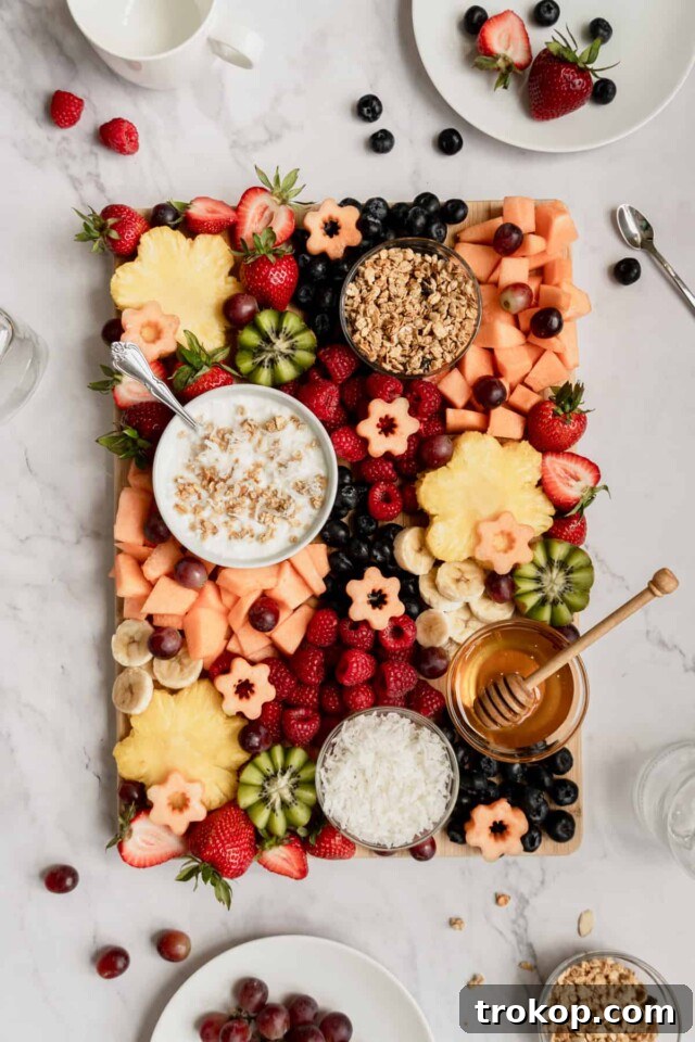 Brilliant Fruit Platter Ideas and Expert Presentation Tips 12 A breakfast and brunch fruit platter featuring a variety of fresh fruits, bowls of Greek yogurt, granola, shredded coconut, and honey for a customizable parfait experience.