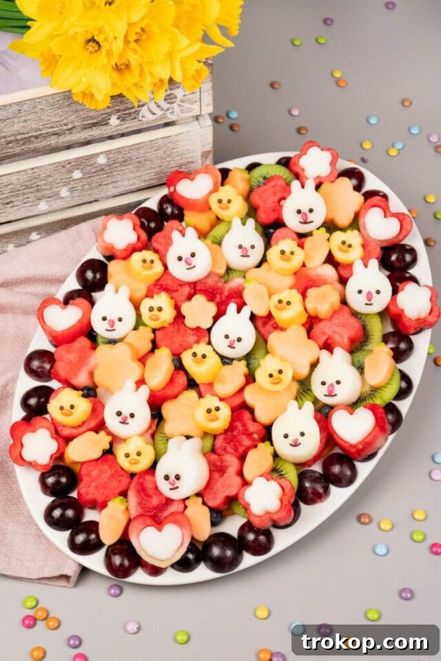 Brilliant Fruit Platter Ideas and Expert Presentation Tips 15 A beautifully arranged fruit platter ideal for Easter celebrations, featuring various spring fruits like berries, grapes, and melon, perfect for a festive party.