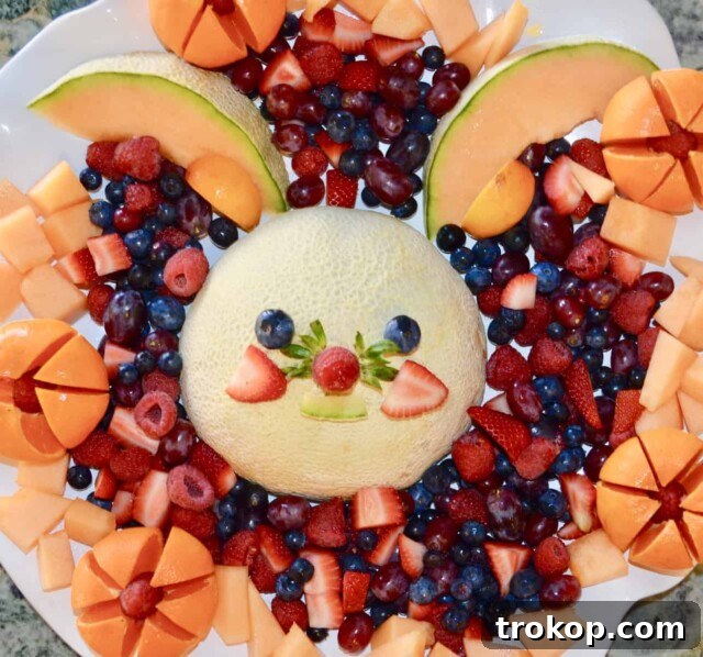 Brilliant Fruit Platter Ideas and Expert Presentation Tips 16 A creative Funny Bunny fruit platter for Easter, featuring a carved cantaloupe as an adorable bunny centerpiece surrounded by colorful berries, grapes, and melon balls.