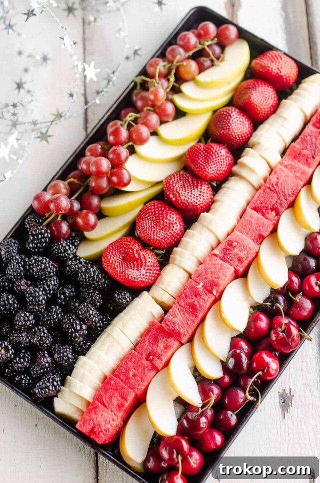 Brilliant Fruit Platter Ideas and Expert Presentation Tips 17 A patriotic flag fruit platter creatively arranged with red strawberries, white yogurt or bananas, and blue blueberries to resemble the American flag for holidays.