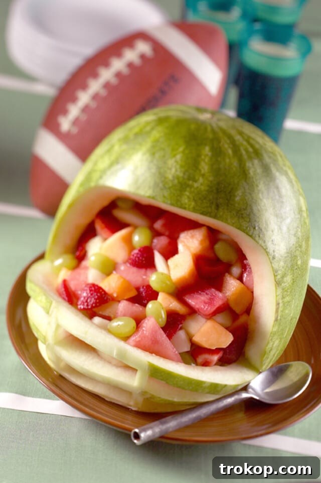 Brilliant Fruit Platter Ideas and Expert Presentation Tips 19 A unique football helmet fruit platter carved from a large watermelon and filled with a colorful fresh fruit salad, perfect for football parties.