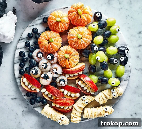 Brilliant Fruit Platter Ideas and Expert Presentation Tips 20 A Halloween-themed freaky fruit platter with creepy creations like ghoulish grape snakes with candy eyes, eerie apple fangs, and unsettling lychee eyeballs.