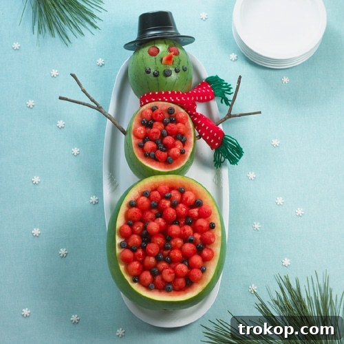 Brilliant Fruit Platter Ideas and Expert Presentation Tips 26 A whimsical watermelon snowman fruit platter, intricately carved from stacked watermelons and filled with a fresh, colorful fruit salad, ideal for Christmas festivities.