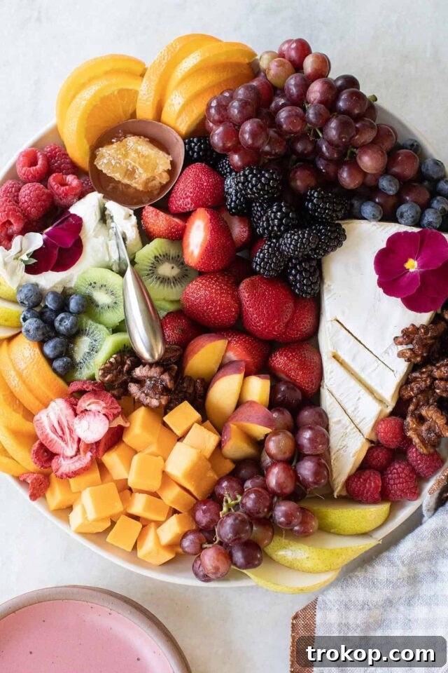 Brilliant Fruit Platter Ideas and Expert Presentation Tips 4 A sophisticated fruit and cheese platter with assorted cheeses, grapes, strawberries, and chopped walnuts or pecans.