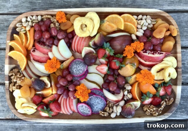 Brilliant Fruit Platter Ideas and Expert Presentation Tips 6 A colorful winter fruit salad for a festive fruit platter, showcasing juicy citrus, crisp apples, and sweet pomegranate seeds.