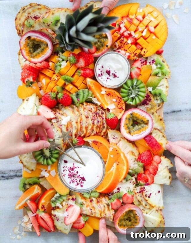 Brilliant Fruit Platter Ideas and Expert Presentation Tips 8 An exotic tropical fruit platter showcasing vibrant mangoes, pineapples, papayas, star fruit, and fresh coconut shards.