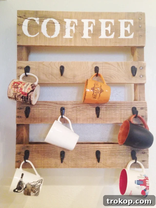Charming DIY pallet coffee cup holder, perfect for displaying mugs and saving cabinet space in a rustic kitchen setting