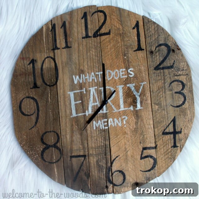 Rustic DIY clock made from pallet wood, serving as functional farmhouse-style decor with a witty message on the wall