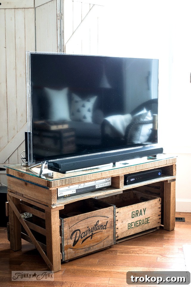 DIY pallet TV stand project with a glass top display case, offering a rustic yet functional media console for any living room