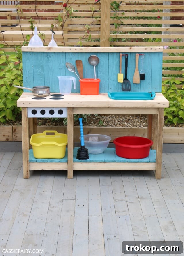 Outdoor mud kitchen for kids made from pallet wood, encouraging sensory play and outdoor fun, a perfect pallet wood project idea