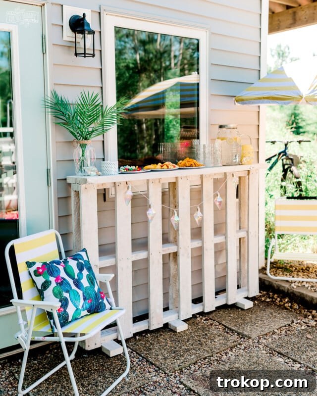Easy to build DIY pallet bar providing additional tabletop space for entertaining guests in the backyard, enhancing outdoor living