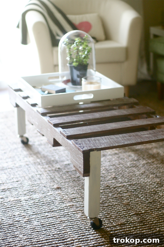 Stylish DIY pallet coffee table by Sugar & Cloth, featuring a sleek design for modern living rooms, embodying creative upcycling
