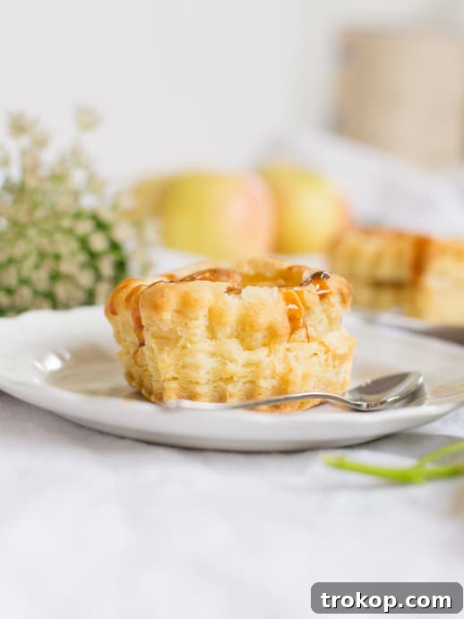 Various mini apple tarts on a cooling rack
