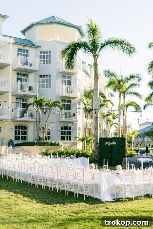 Beaches Turks and Caicos Sunset Vows by the Sea 24 Wedding reception area being expertly set up on a lush green lawn for the evening celebration