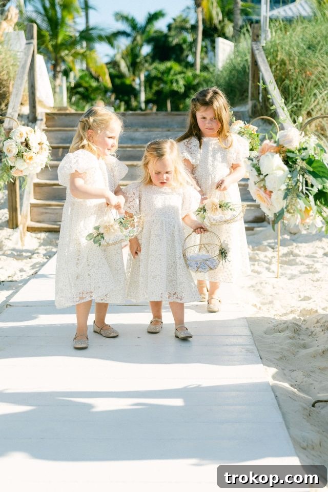 Beaches Turks and Caicos Sunset Vows by the Sea 30 Flower girls walking down the sandy aisle, enjoying their role in the wedding