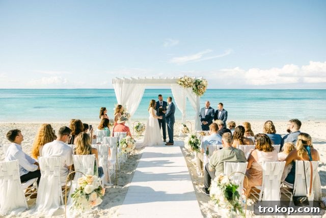 Beaches Turks and Caicos Sunset Vows by the Sea 33 Close-up of the bride and groom holding hands during their heartfelt vows