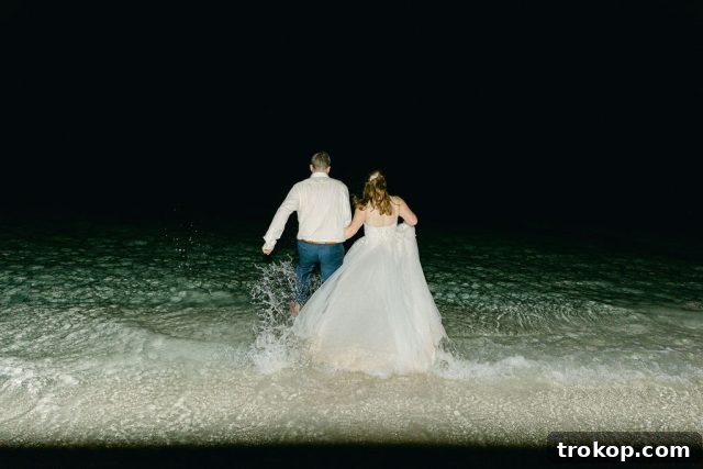 Beaches Turks and Caicos Sunset Vows by the Sea 55 The couple walking towards the ocean for a post-reception celebration