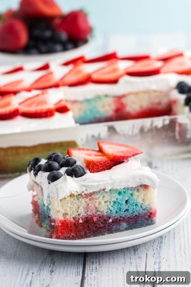 A festive Fourth of July poke cake with red and blue jello infusing the cake