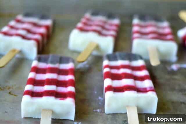Refreshing red, white, and blueberry yogurt popsicles, a healthy summer treat