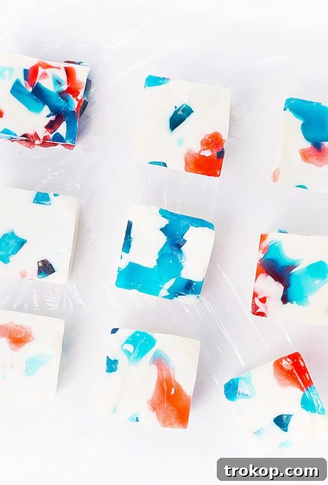 Layered red, white, and blue jello shots, perfect for patriotic gatherings
