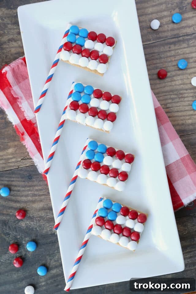 Kid-friendly graham cracker flags decorated with red, white, and blue candies