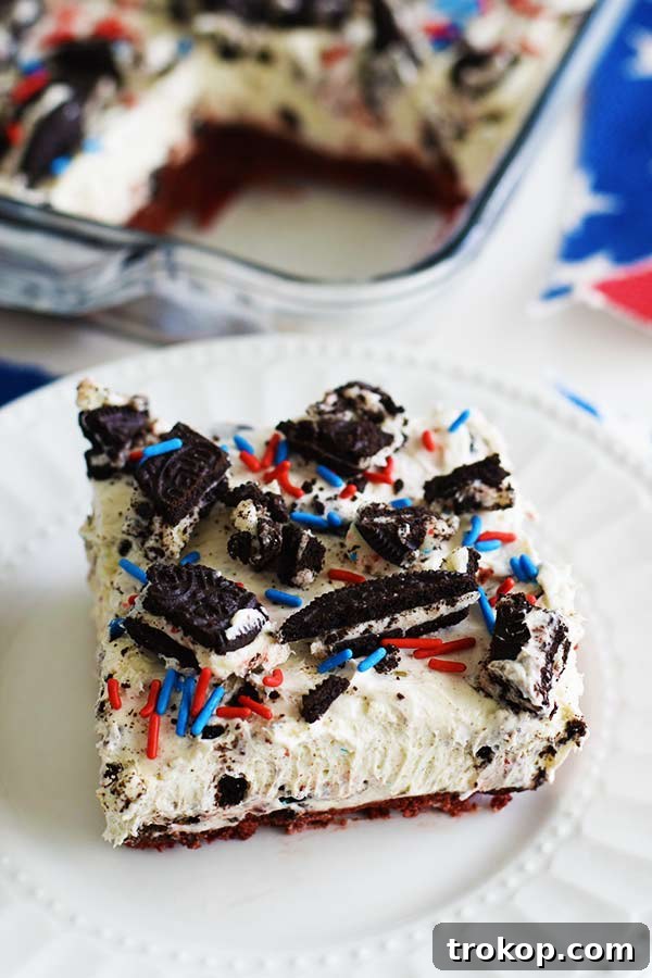 Slice of no-bake firework Oreo cheesecake with colorful sprinkles