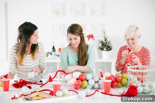 Friends enjoying a DIY holiday craft party, making ornament garlands