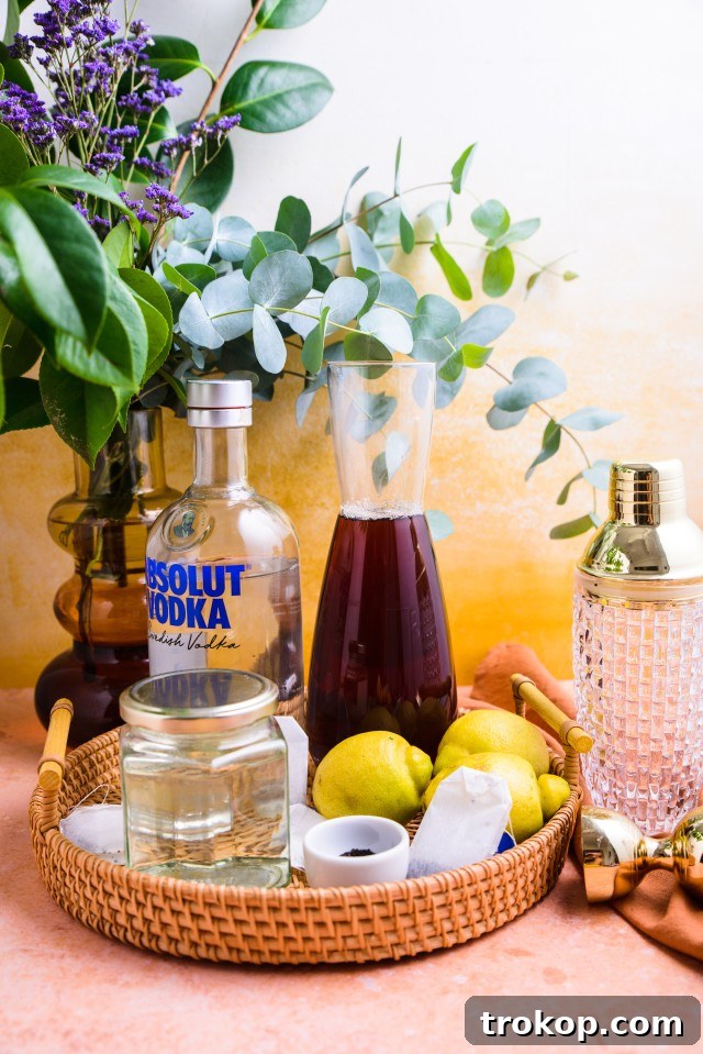Fresh ingredients laid out for making Spiked Arnold Palmer cocktails: lemons, tea, and vodka.