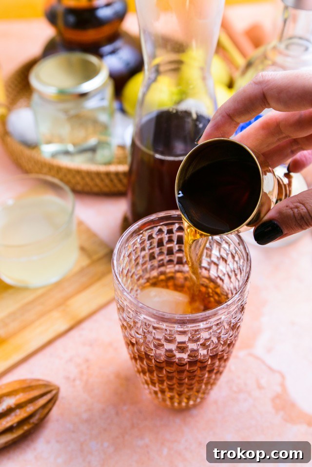 A mixologist preparing a Spiked Arnold Palmer cocktail in a shaker.