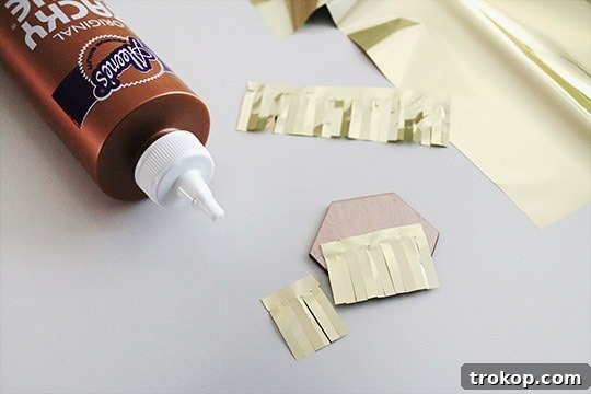 Cutting fringe strips for DIY Gold Fringe Drink Toppers.